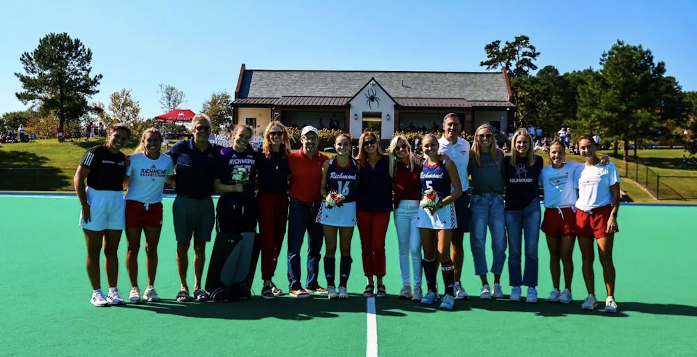 Members of the University of Richmond's field hockey team celebrating senior day with their friends and family. Courtesy of Richmond Athletics.