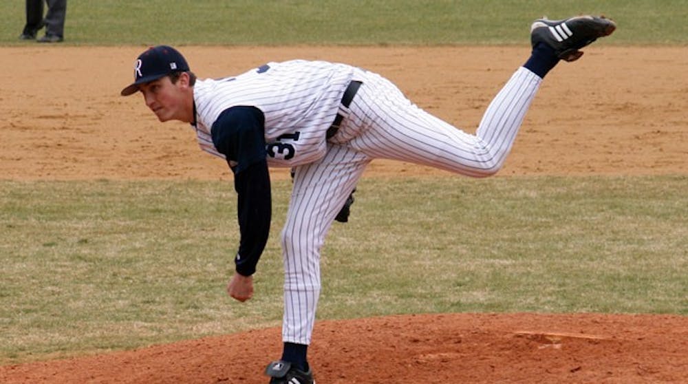 Daniel Clark (# 31) warms up before the 7th inning and practices pitching