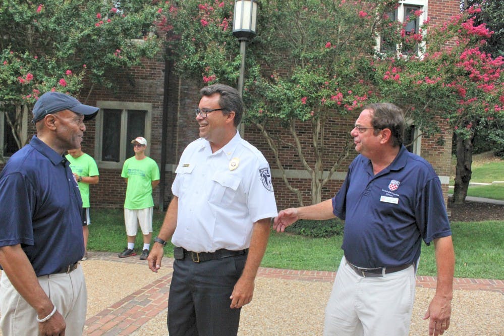 President Crutcher (left) and Steve Bisese (right), Vice President for Student Development, ran into URPD Chief Dave McCoy in front of Lora Robins 