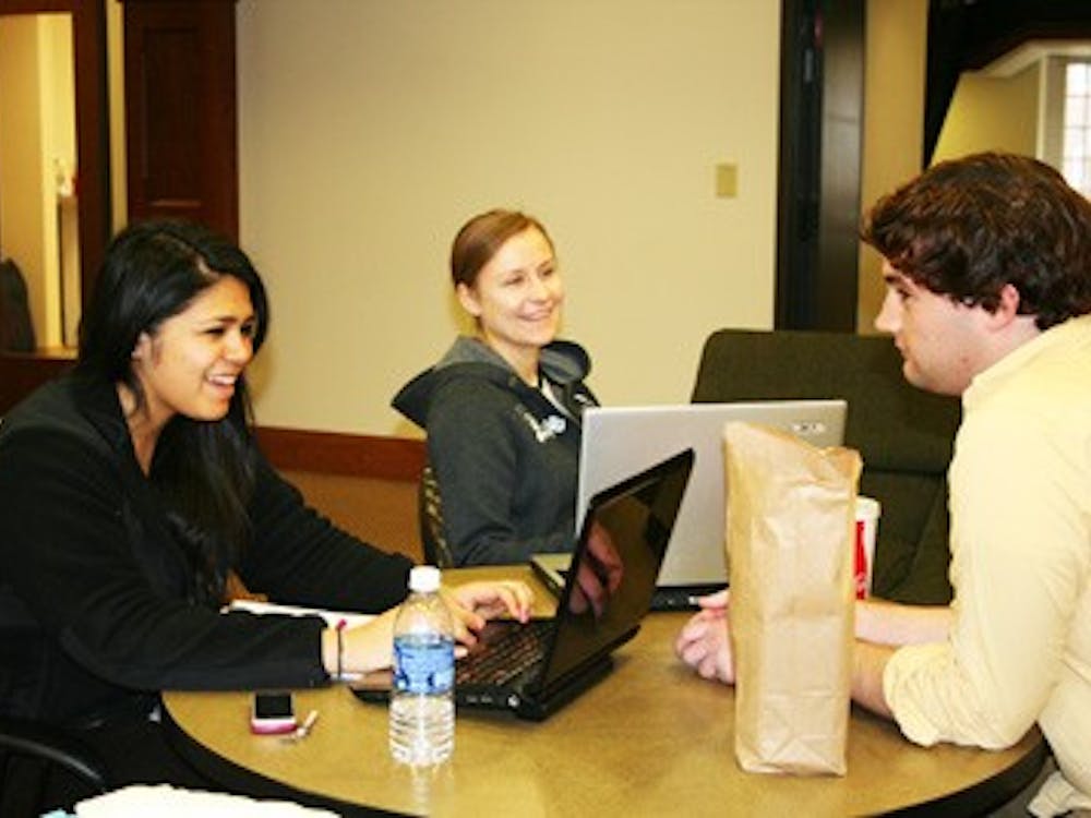 Michelle Garcia, Alisa Emelianova and Adam Ferguson enjoy their lunch and do work in the second floor lounge of Lakeview Hall. 