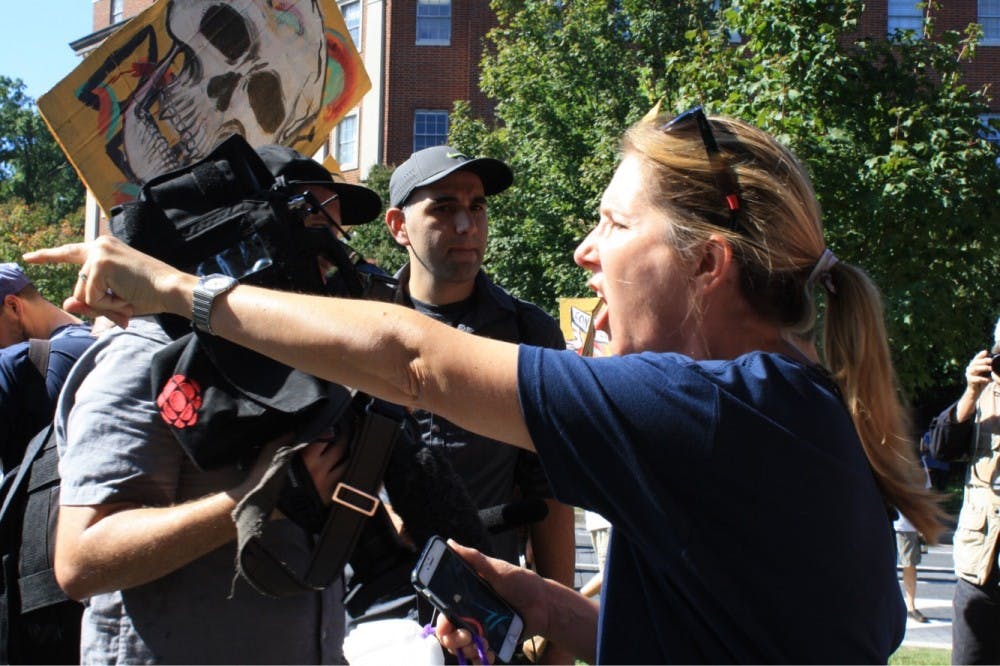 A counter protester shouts back and forth with members of the Confederate group.&nbsp;