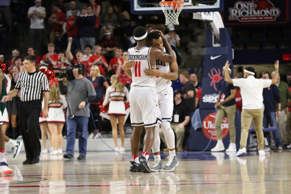 <p>Freshman De'Monte Buckingham supports his teammate in the wake of a tough loss to George Mason at home on Sunday. Photo courtesy of Richmond Athletics</p>