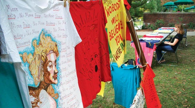 Sophomore Courtney Lund monitors a table promoting The Clothesline Project outside Boatwright Memorial Library Tuesday afternoon.  The project is aimed at addressing the issue of violence against women. It honors women survivors as well as victims of intimate violence.Students who were victims of domestic violence or knew victims could make shirts to hang on the line.