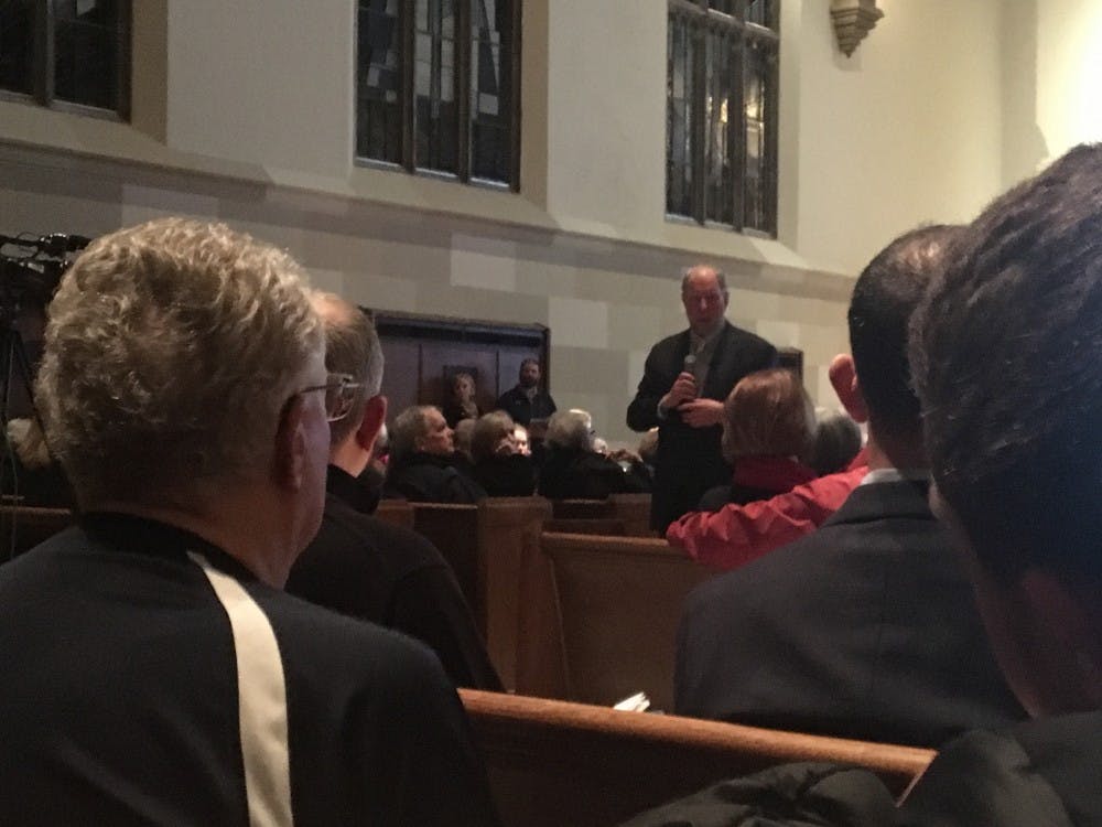 <p>Robert D. Putnam, center, addresses the widening opportunity gap during a discussion Monday night in the Cannon Memorial Chapel.&nbsp;</p>