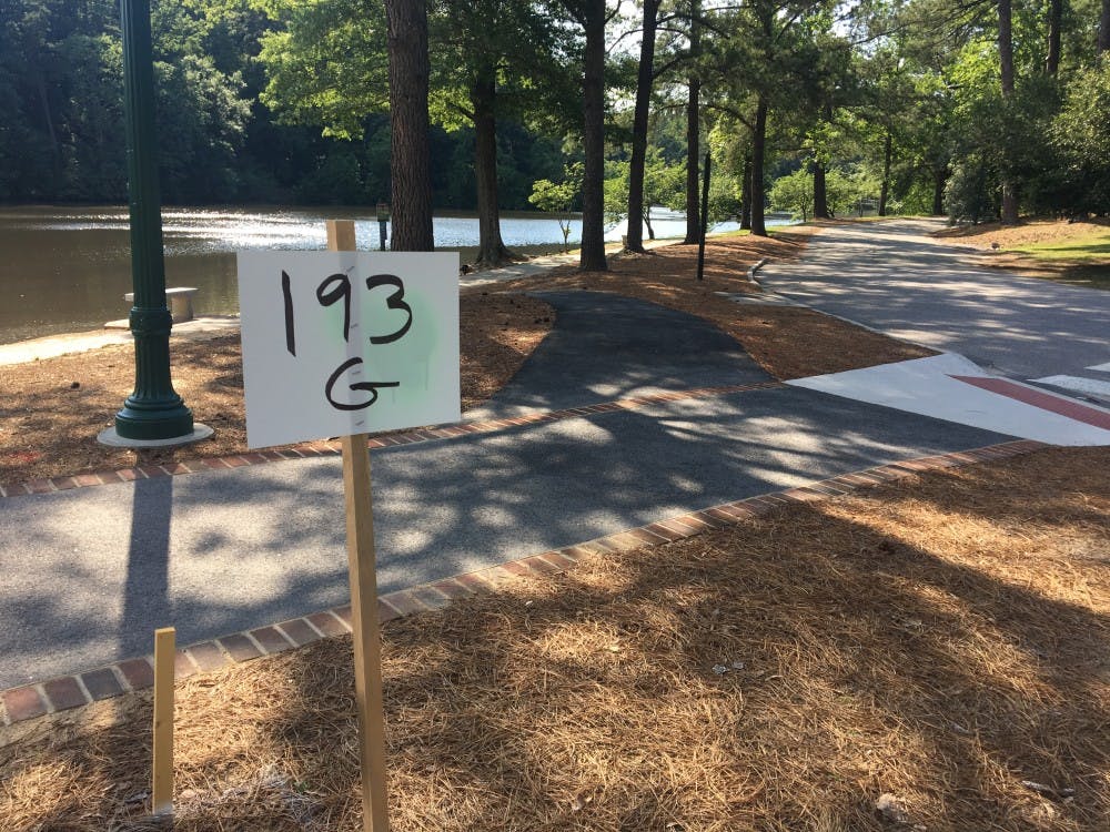 Temporary signs such as this one in front of the entrance to the Lakeview parking lot have been staked across campus as the new wayfinding system becomes implemented over the summer.