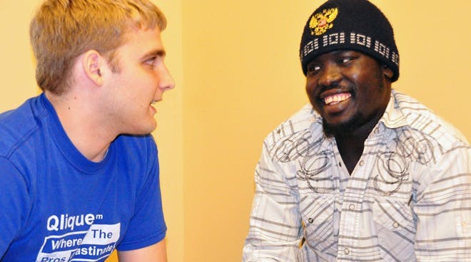 Majak Yai practices reading out of C. S. Lewis's "The Lion, the Witch and the Wardrobe" with one of his tutors, Richmond sophomore Nate Reak. Yai has been taking English lessons through Richmond's ESL Tutoring Project since September.