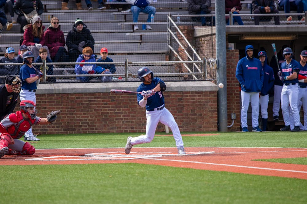 <p>Graduate outfielder Christian Beal swing the bat at the Feb. 26 game against Sacred Heart University.</p>