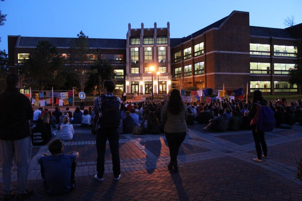 Students gather to listen as survivors of sexual violence and their allies&nbsp;share their stories at Take Back the Night in the Forum.&nbsp;