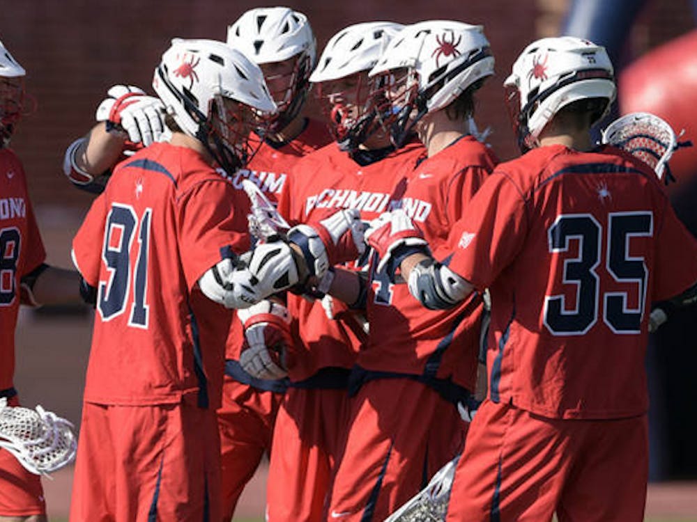 Richmond lacrosse players celebrate after a goal.&nbsp;