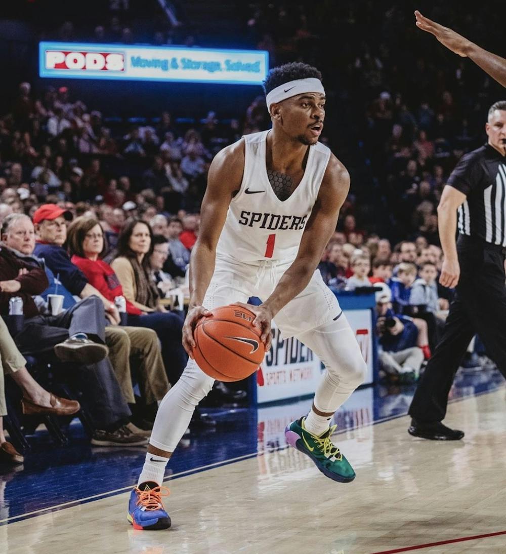 <p>Redshirt junior guard Blake Francis looks to make a pass during the Feb. 29 game against University of Massachusetts Amherst. <em>Photo courtesy of the Spider Athletics Instagram page</em></p>