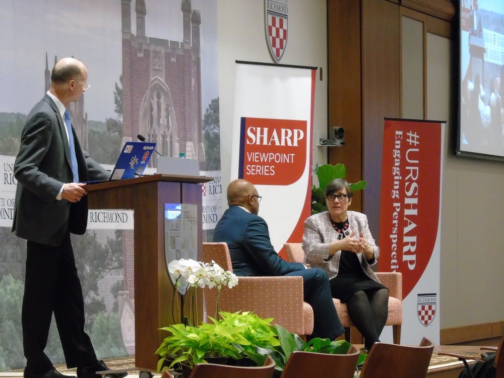 Paula Krebs (right) speaks with President Ronald A. Crutcher (middle) and Executive Vice President and Provost Jeff Legro.
