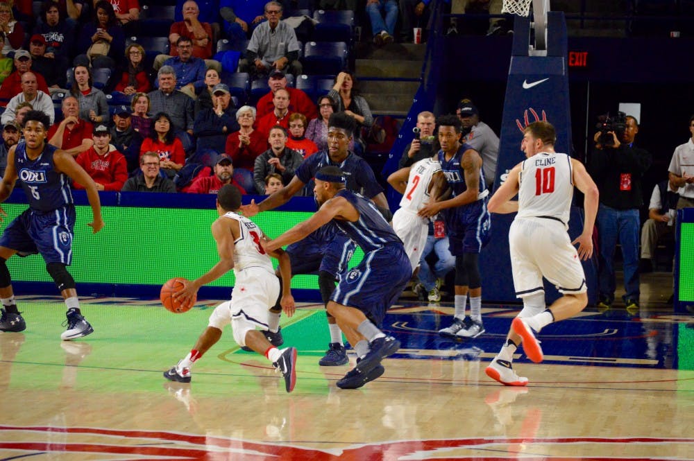 Guard ShawnDre' Jones dribbles past defenders in the second period.