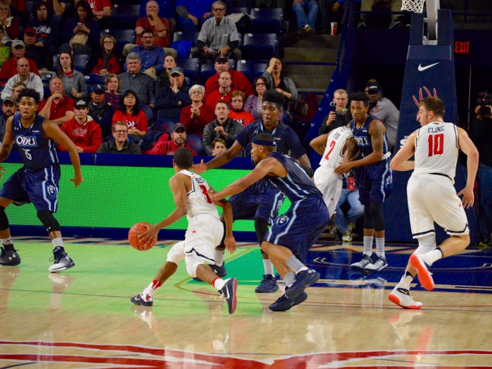 Guard ShawnDre' Jones dribbles past defenders in the second period.
