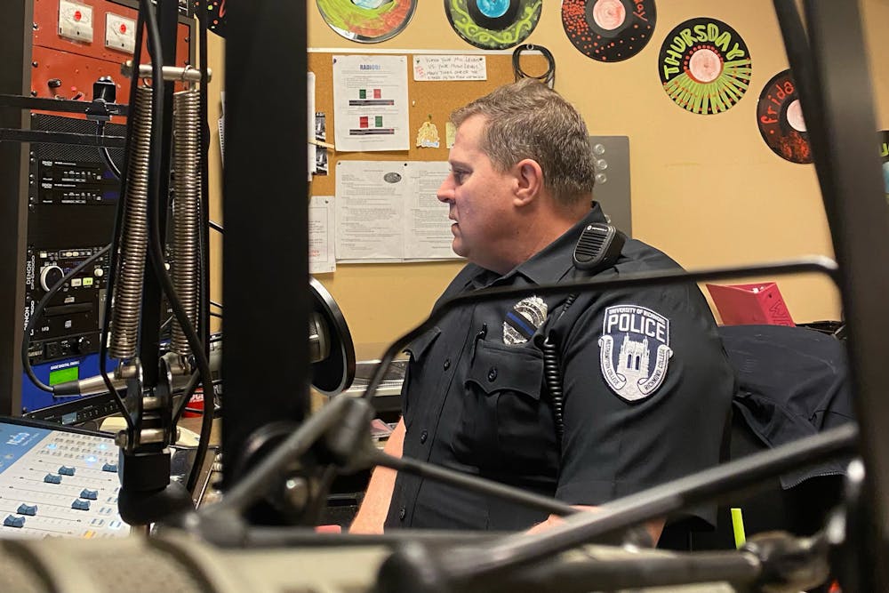 <p>URPD Officer David Selander loads up another CD during his radio show.&nbsp;</p>