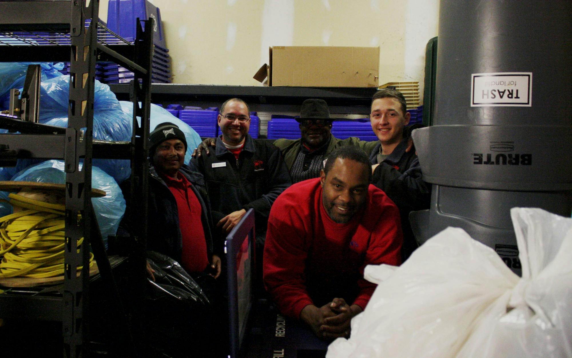 Facilities employees Wa Hit, Mauricio Lopez, James Campbell, John Shines and Jonathan LaPrade (left to right) pose with bags of plastic collected for the Trex initiative in the physical plant storage room where the bags are kept until distribution.