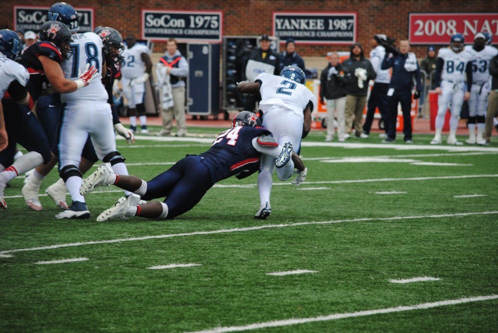 Linebacker Aaron Roane tackles Villanova running back Kevin Monangai for a loss. 