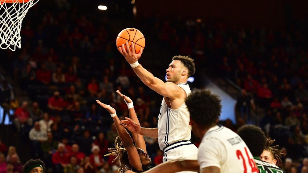 <p>Senior forward Tyler Burton shoots for a score at the Robins Center on March 4.&nbsp;</p>