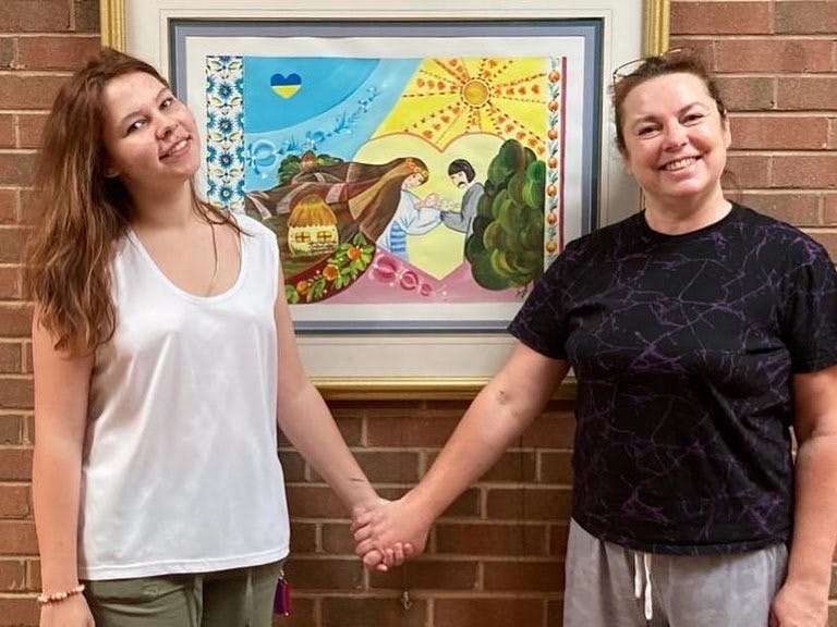 Photo of Iryna Litvinov and Olena Litvinov at the Refugee Art Show in St. Michael's Episcopal Church in Bon Air, Virginia. Photo courtesy of the Litvinov family.&nbsp;