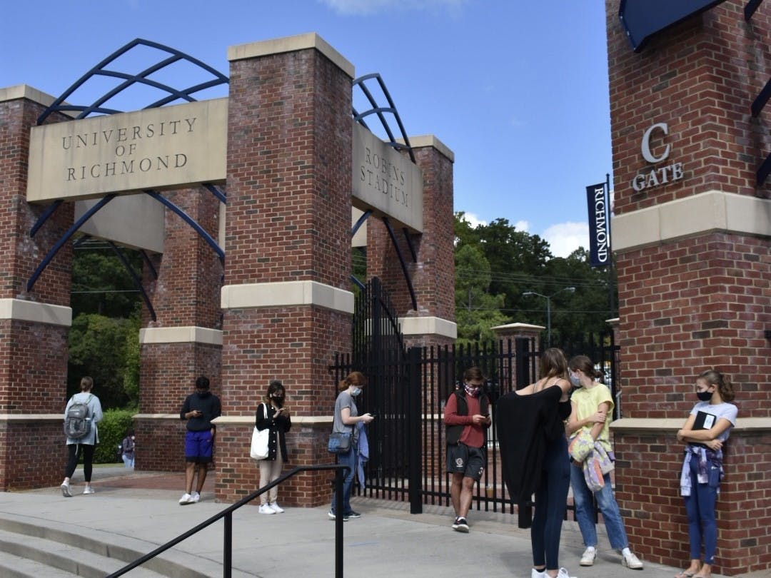 Masked students line up outside of Robin's stadium to receive their annual flu shot during the COVID-19 pandemic.&nbsp;