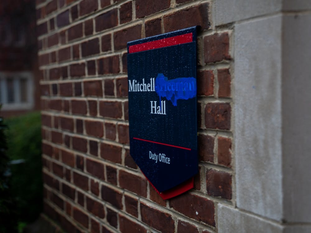 The miniature signage surrounding Mitchell-Freeman hall remains, with the word "Freeman" blocked out with blue paint.