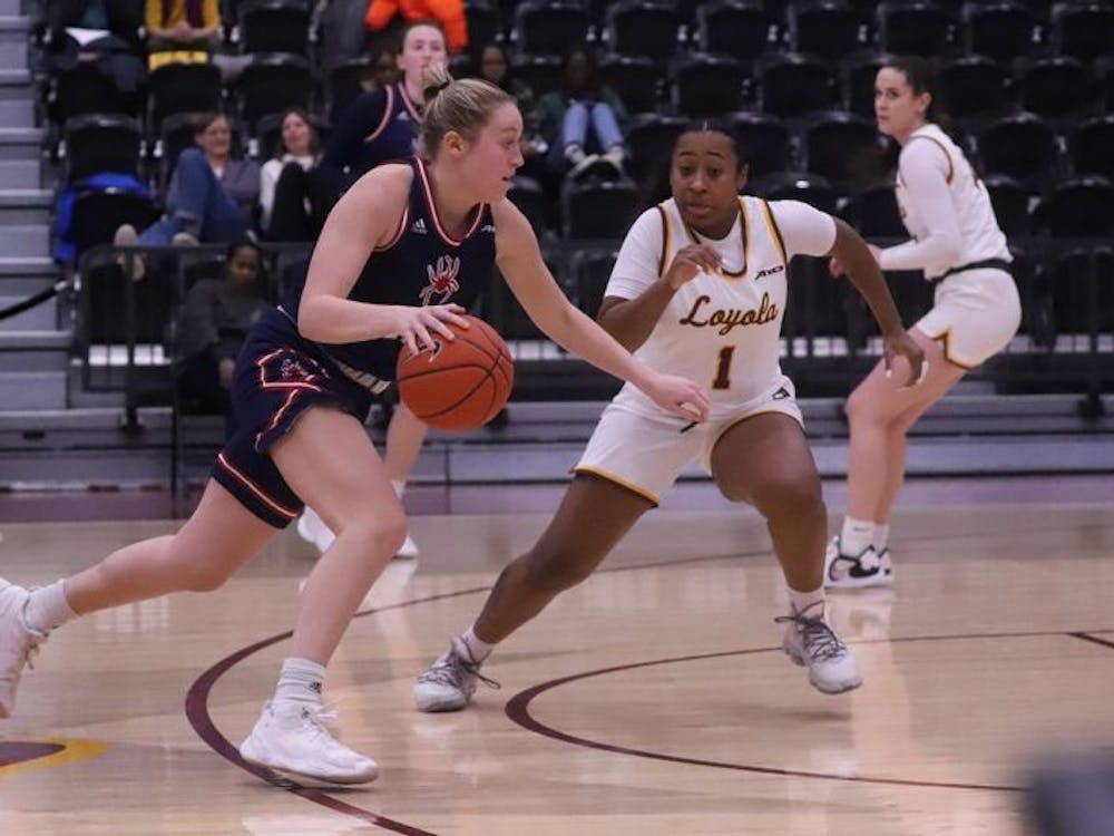 Sophomore guard Katie Hill dribbles past a Loyola University Chicago player during away game on Jan 4. at the Gentile Arena in Loyola University Chicago's campus. Photo courtesy of Richmond Athletics.&nbsp;