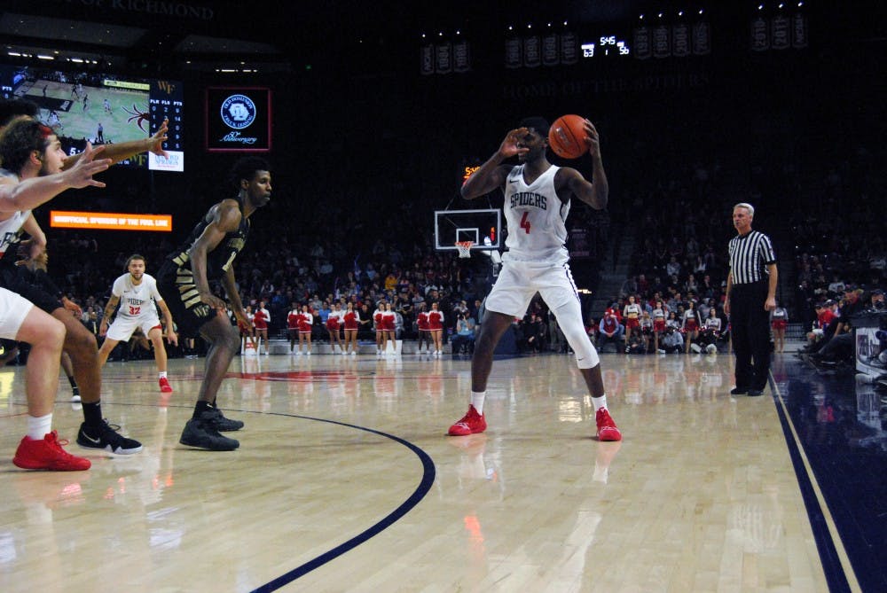 <p>Sophomore forward Nathan Cayo receives a pass during the Spiders' win Wednesday, Dec. 5 against Coppin State.&nbsp;</p>