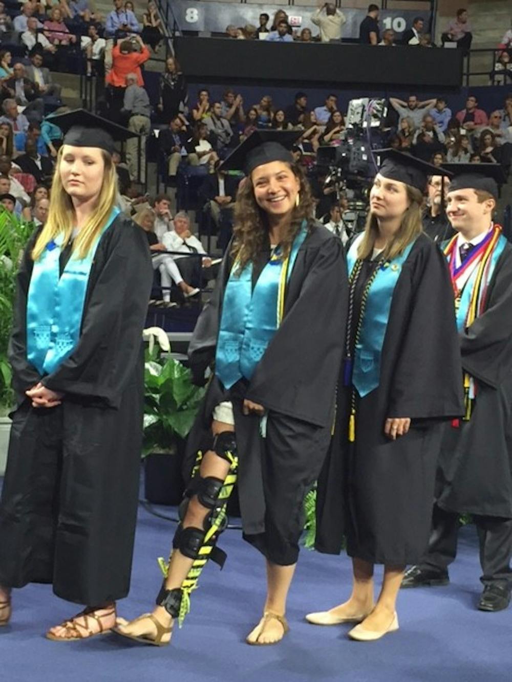 <p>Kobb, walks with her leg brace&nbsp;amongst fellow Jepson seniors at graduation on May 8, 2016.</p>