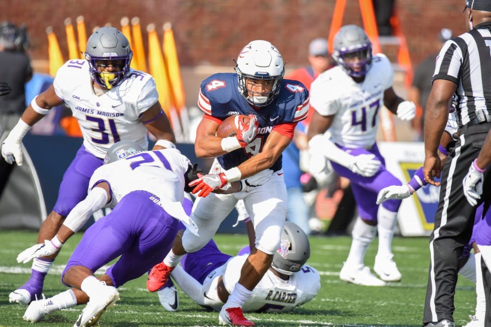First-year running back Aaron Dykes runs through the JMU defense Saturday afternoon.&nbsp;