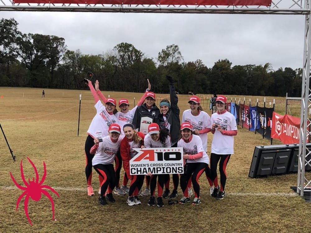 The women's cross country team celebrates their Atlantic-10 Conference championship. Photo courtesy of @spiderathletics Instagram.