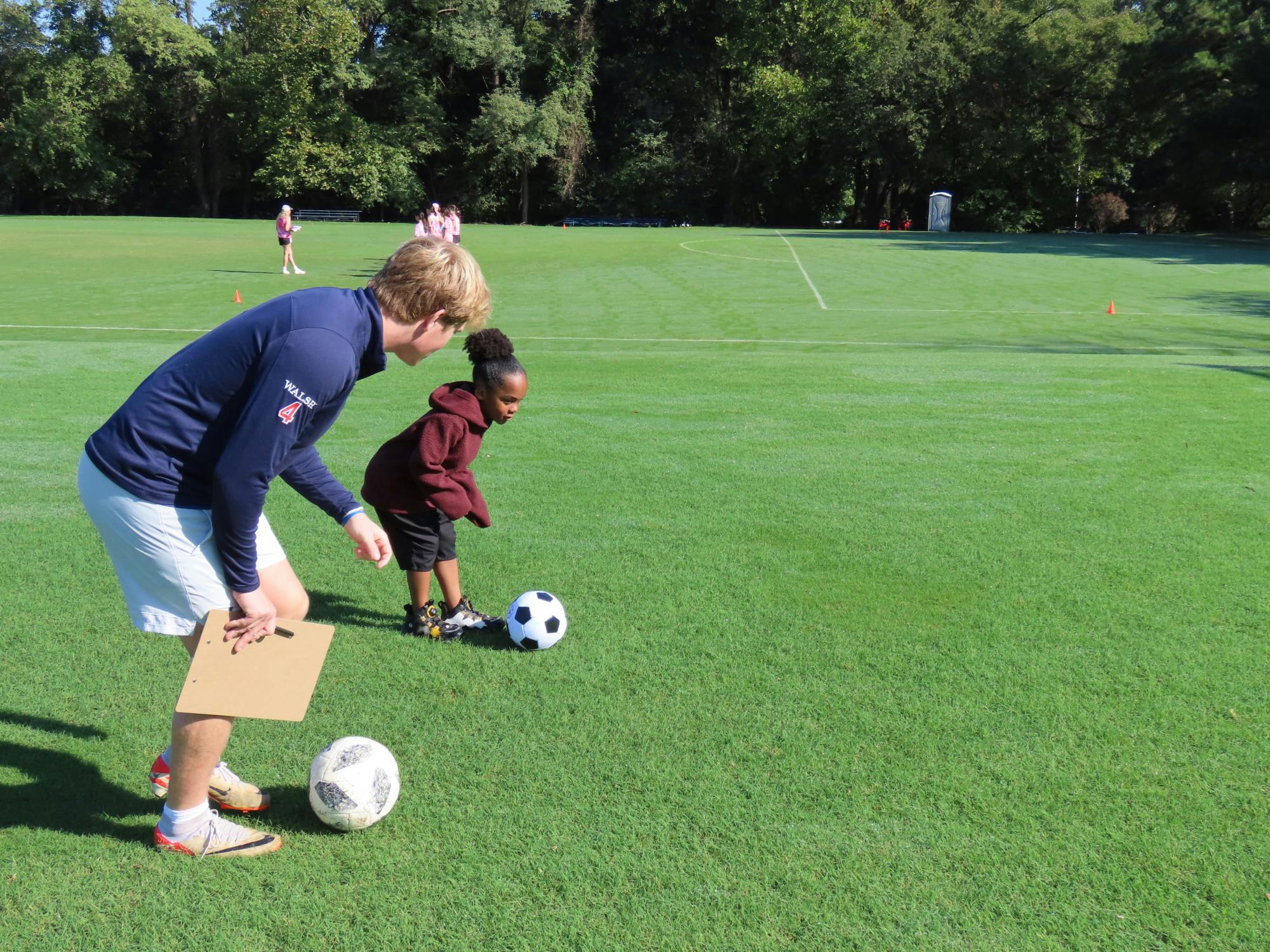Sophomore Gordon Walsh helps a child hone their soccer skills. Photos courtesy of Jack Raiz.