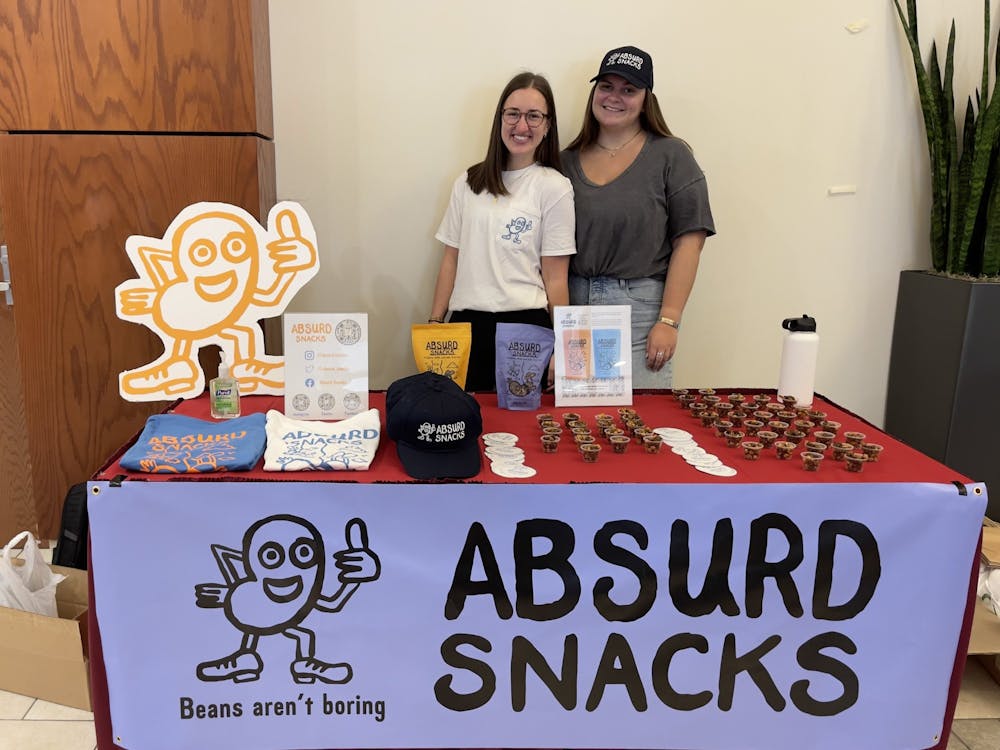 Students promote Absurd Snacks outside of Everything Convenience on March 21.