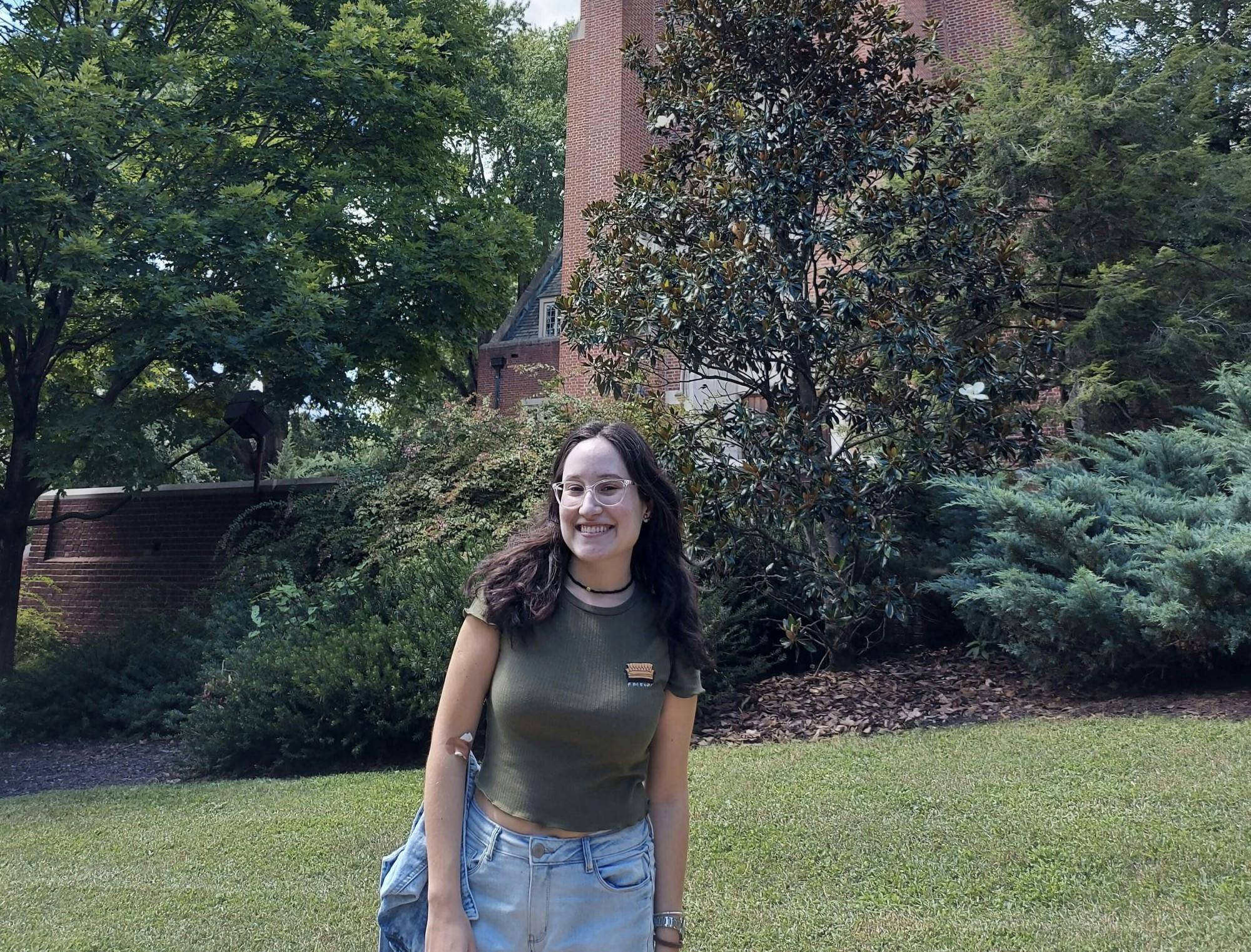 Senior Letícia de Almeida Sbrocca poses in front of Boatwright Memorial Library. Photo courtesy of Letícia de Almeida Sbrocco.&nbsp;