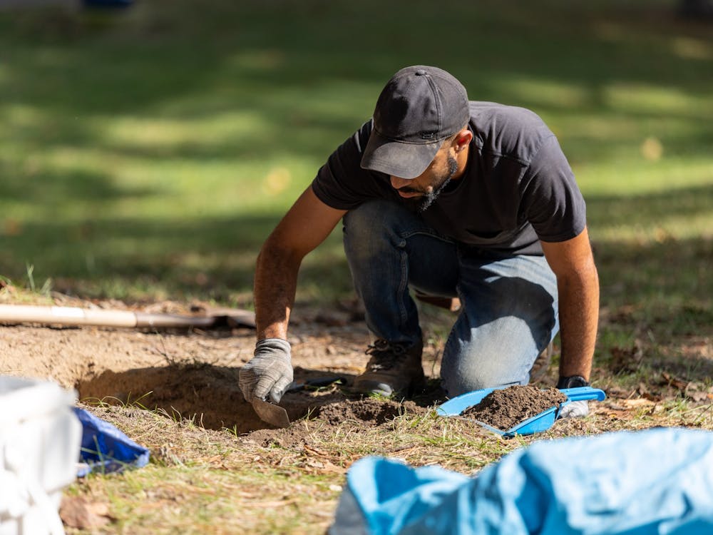 Archeologist Tim Roberts conducts fieldwork at the Westham Burying Ground on Sept. 14.