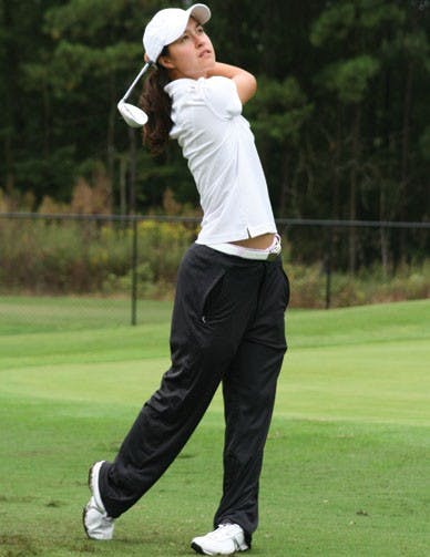 Senior Annie Sprick on the driving range during a practice at the UR Golf Facility.