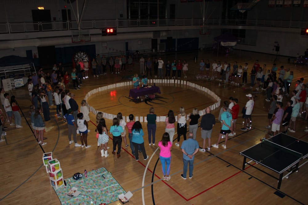 <p>Relay for Life participants came together in a circle and dedicated a luminaria to a loved one who had or is currently fighting against cancer on April at the Weinstein Center for Recreation. Photo courtesy of Kate Amabile.&nbsp;</p>