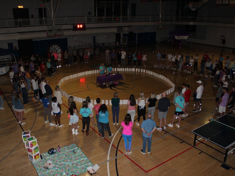 Relay for Life participants came together in a circle and dedicated a luminaria to a loved one who had or is currently fighting against cancer on April at the Weinstein Center for Recreation. Photo courtesy of Kate Amabile.&nbsp;