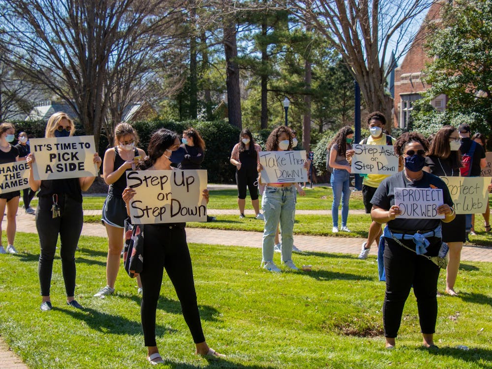Protesters stand socially distanced at the silent protest in the Stern Quadrangle.
