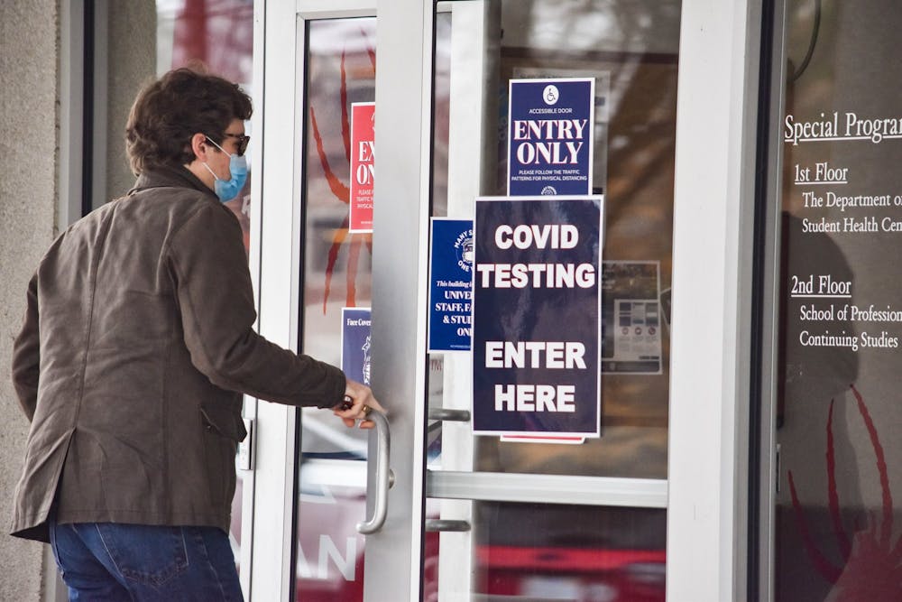 <p><em>A student enters the Special Programs building, where prevalence tests were administered in spring 2021. UR will not offer prevalence testing in 2022. Photo by Ethan Swift.</em></p>