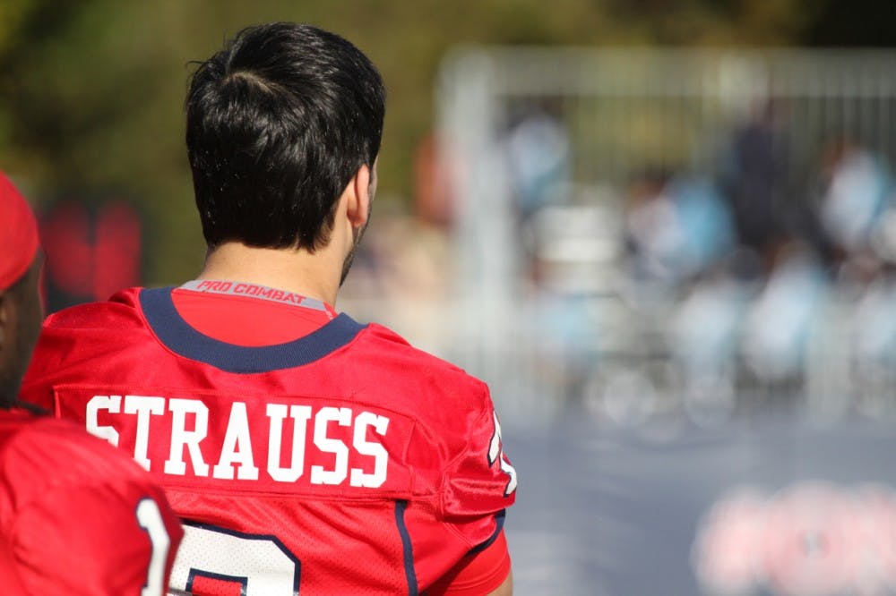 <p>Injured quarterback Michael Strauss looks on from the sidelines during Richmond's Homecoming Game.</p>