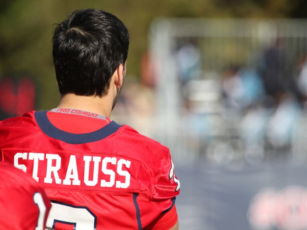 Injured quarterback Michael Strauss looks on from the sidelines during Richmond's Homecoming Game.