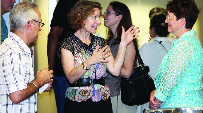 Dean Kathleen Skerrett talks to faculty members at the "Meet and greet" in the administrative wing of bOATWRIGHT LIBRARY.