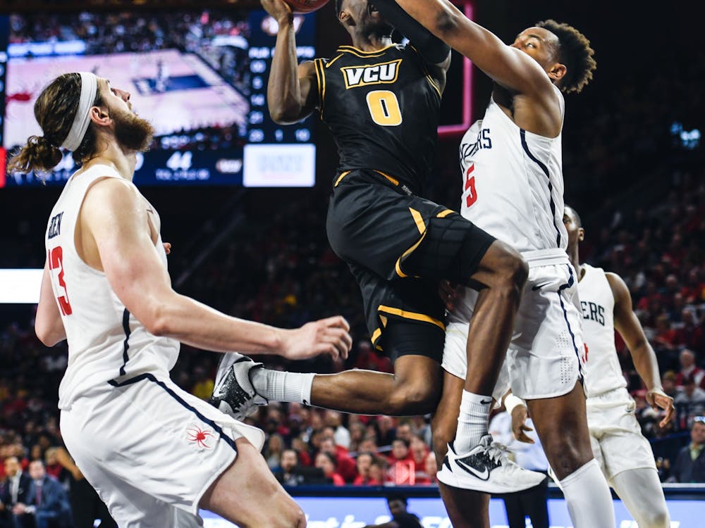Redshirt junior guard Nick Sherod reaches to block a shot by VCU during a game at the Robins Center on Saturday, February 15, 2020.