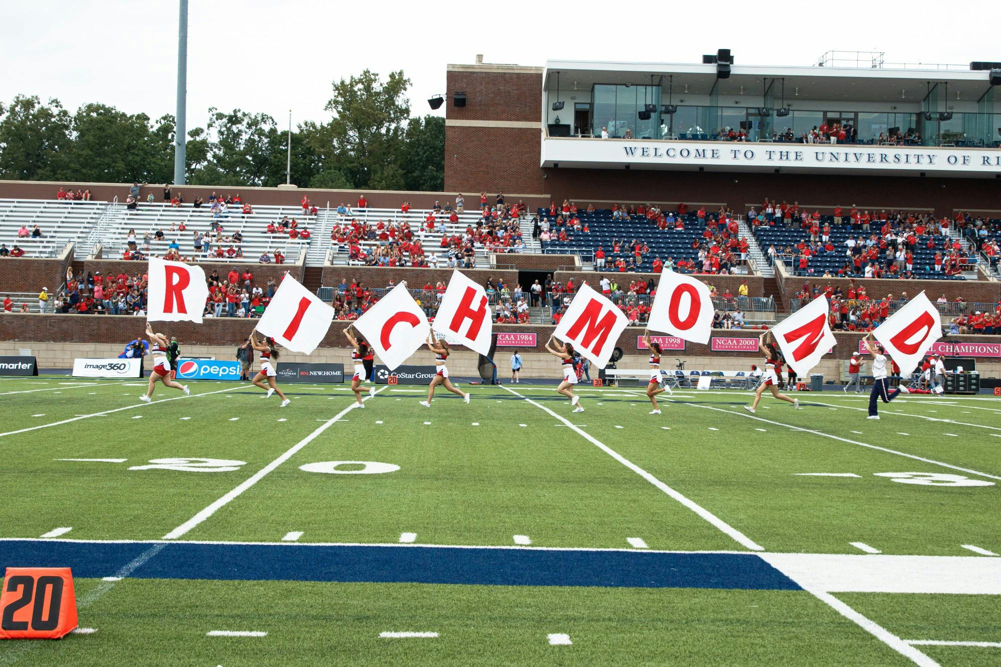 Cheerleaders spread Richmond banner across the field on Sept. 10.