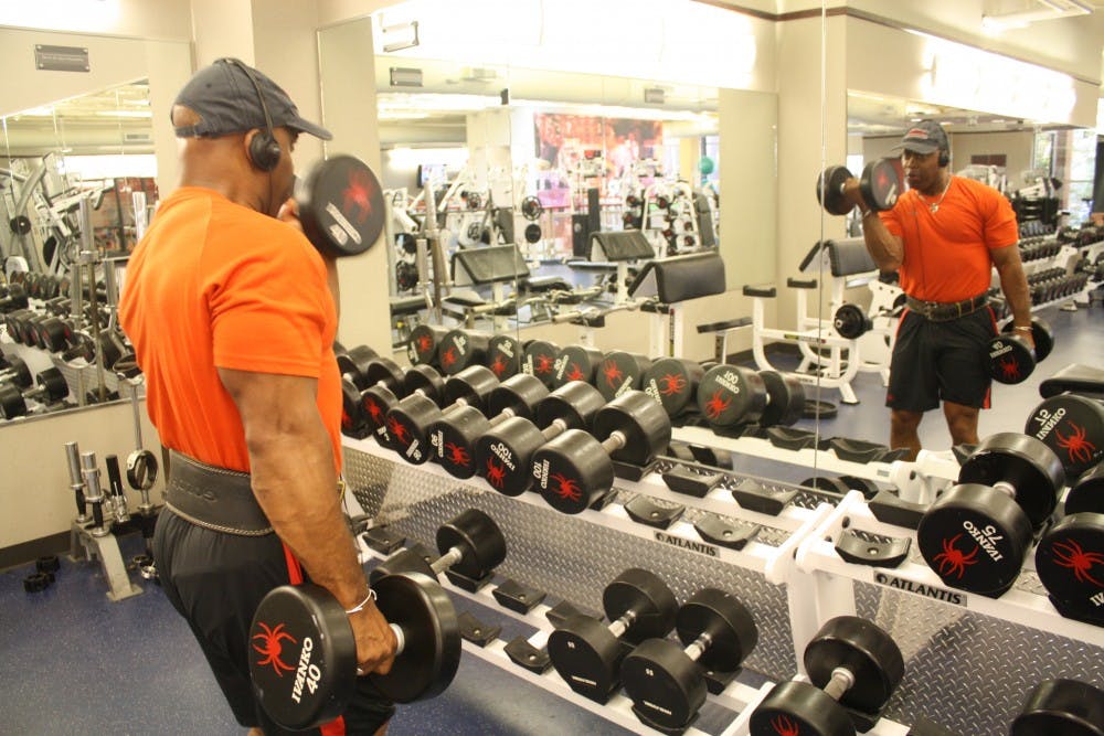 <p>Officer David Johnson lifts weights at the Weinstein Center for Recreation on campus. Photo by Anna Cable.</p>