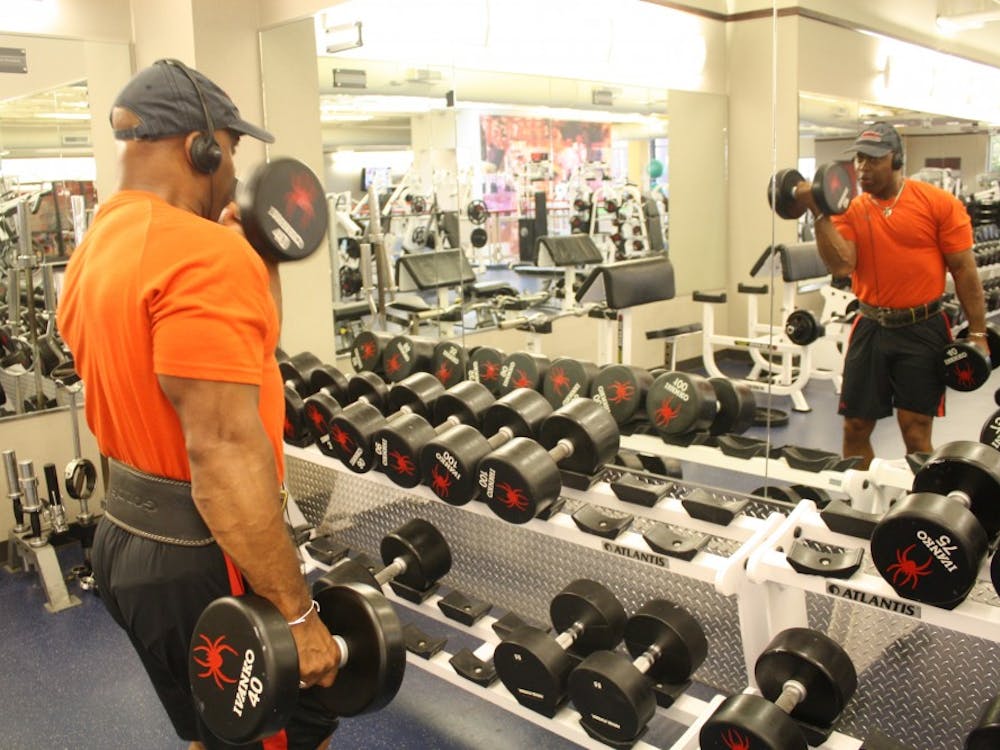 Officer David Johnson lifts weights at the Weinstein Center for Recreation on campus. Photo by Anna Cable.