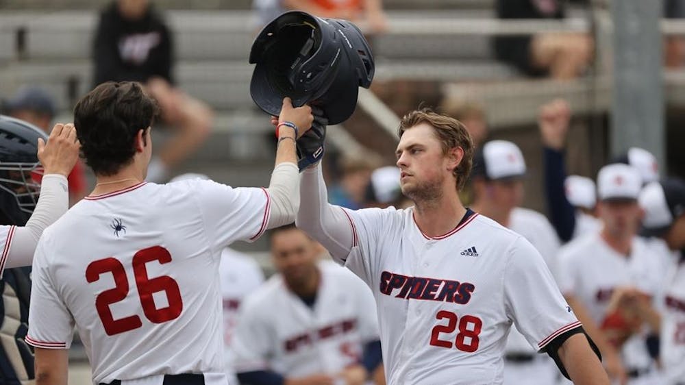 <p>First-year Jake Elbeery and junior Will Gersky knock helmets at the game against Longwood University on April 5 at Pitt Field. Photo courtesy of Richmond Athletics.</p>