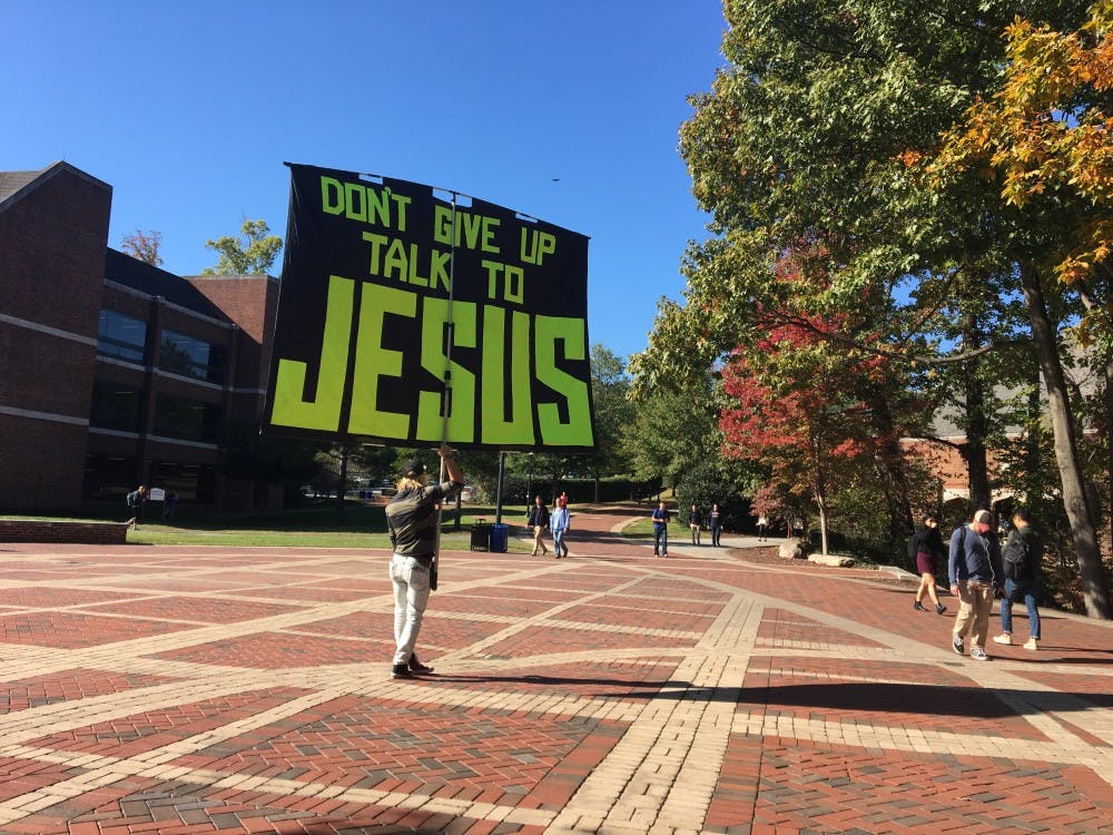 <p>The demonstrator, who is not a member of the UR community, shouted anecdotes at students walking to class. He emphasized the difference between&nbsp;Jesus and the church. <em>Photo by Liza David.&nbsp;</em></p>