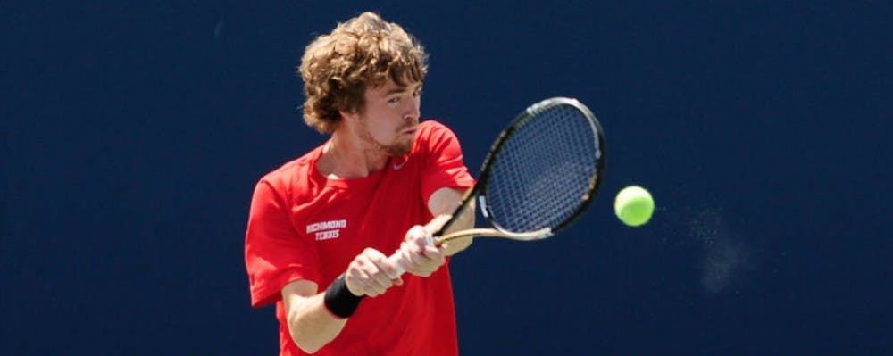 Senior Ethan Dunbar strikes the ball during a match against Navy. He is the Spiders' only nationally ranked player at number 125. 