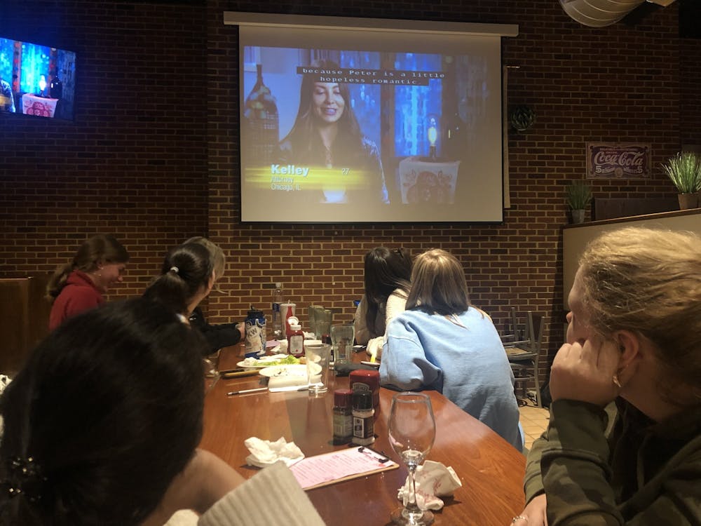 <p>Students watch an episode of "The Bachelor," a popular reality television show. The Cellar, UR’s on-campus restaurant, is now hosting “Bachelor Mondays,” showing the episodes as they air each week, starting at 8 p.m.&nbsp;</p>