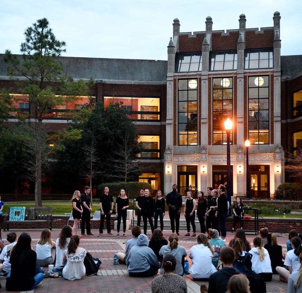 <p>Choeur du Roi performs a song in front of the crowd gathered for Take Back the Night.&nbsp;</p>